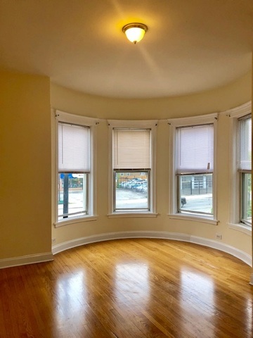 6263 North Clark Street, Unit 2 Chicago, IL 60660 - Photo 8 of 14 a view of an empty room with wooden floor and a window