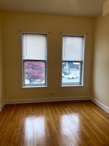 6263 North Clark Street, Unit 2 Chicago, IL 60660 - Photo 9 of 14 a view of an empty room with wooden floor and a window