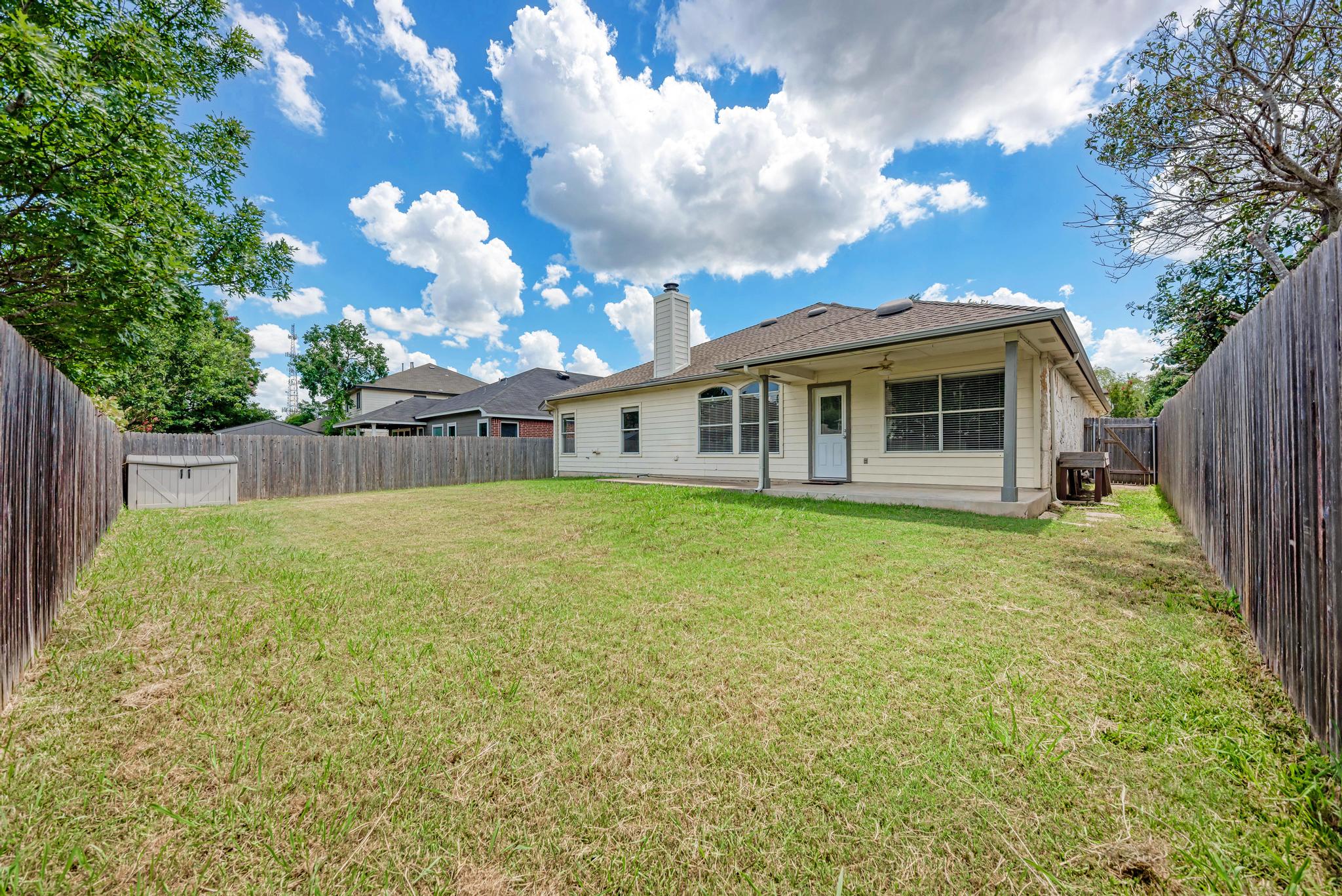 4408 Tello Path Austin, TX 78749 - Photo 34 of 38 Rear view of house featuring a fenced backyard, a chimney, ceiling fan, and a patio area