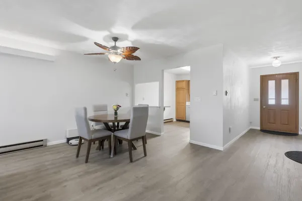 a view of a dining room with furniture and wooden floor