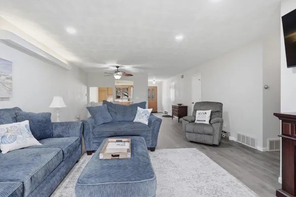 a living room with furniture and a wooden floor