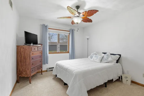 a bedroom with a bed and a television