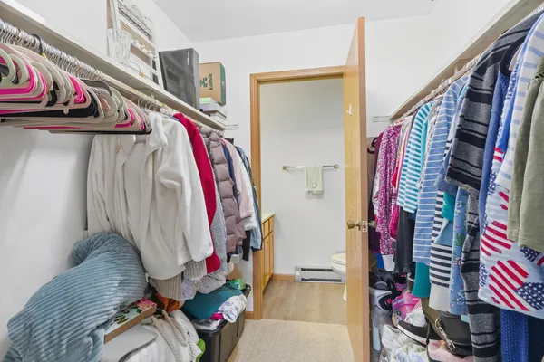 a view of walk in closet with clothes