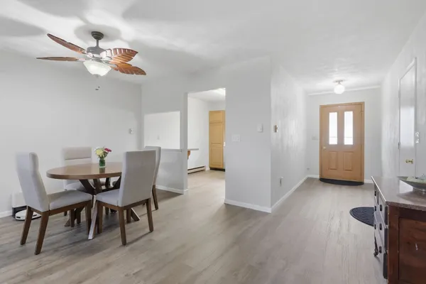 a view of a dining room with furniture and wooden floor
