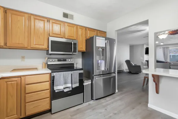 a kitchen with stainless steel appliances a stove microwave and a refrigerator