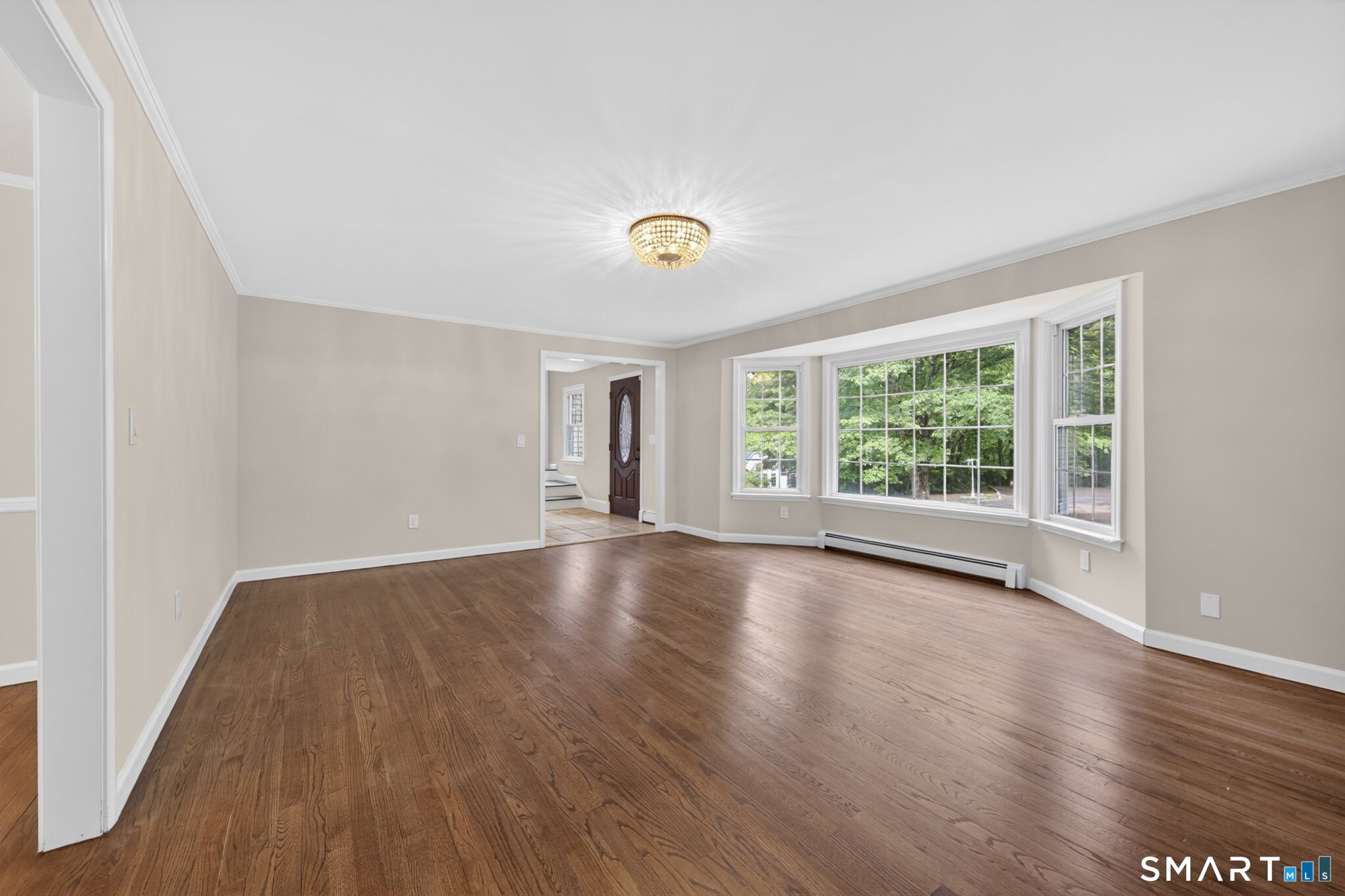 70 Barrack Hill Road Ridgefield, CT 06877 - Photo 11 of 32 an empty room with wooden floor and windows