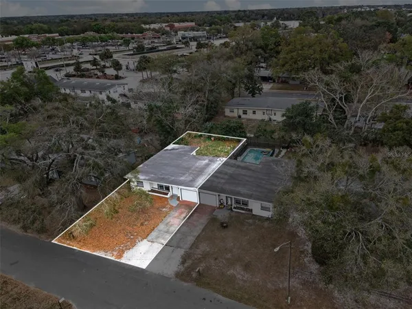an aerial view of a house with a yard