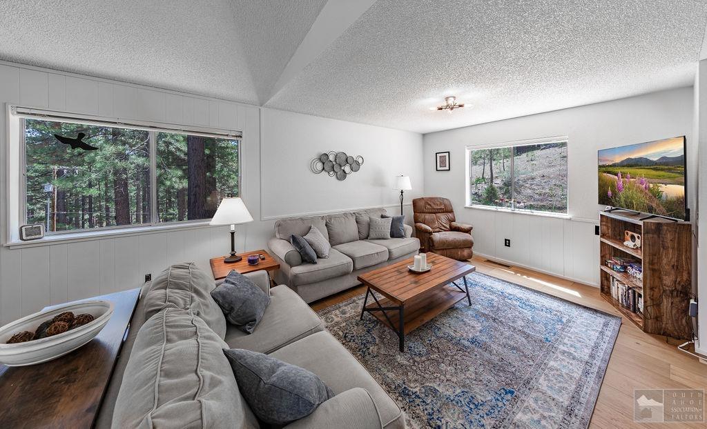 270 Timber Lane Markleeville, CA 96120 - Photo 2 of 24 a living room with furniture a flat screen tv and a large window