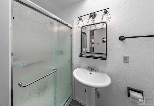 a bathroom with a sink and mirror