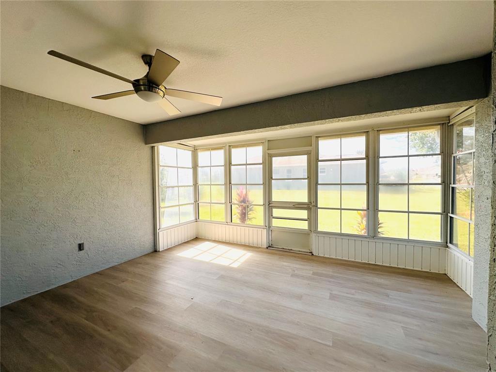 9706 Southwest 92nd Place Road Ocala, FL 34481 - Photo 29 of 82 a view of an empty room with a window and wooden floor