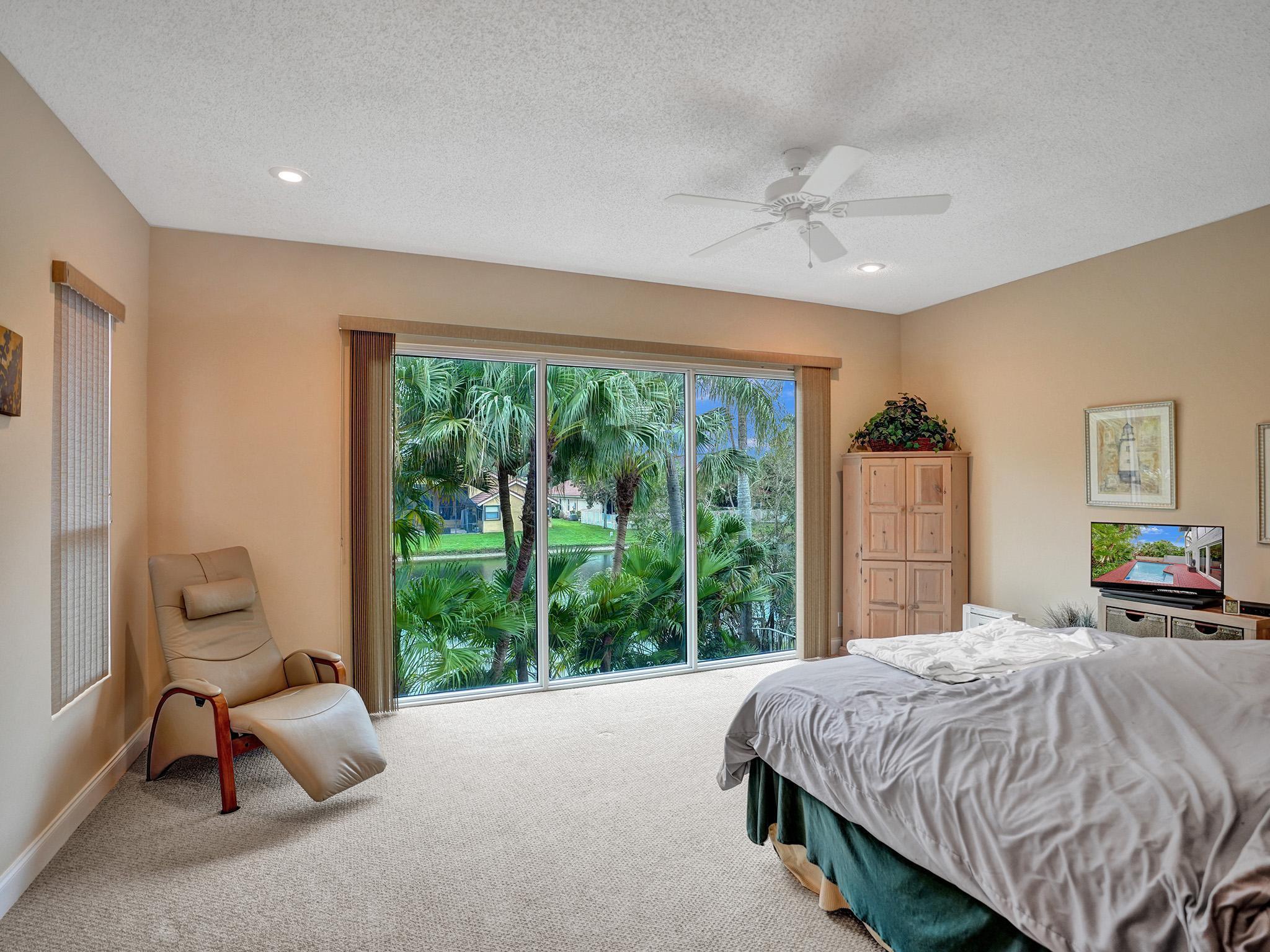 17288 Hampton Boulevard Boca Raton, FL 33496 - Photo 11 of 36 a bedroom with a bed and large windows
