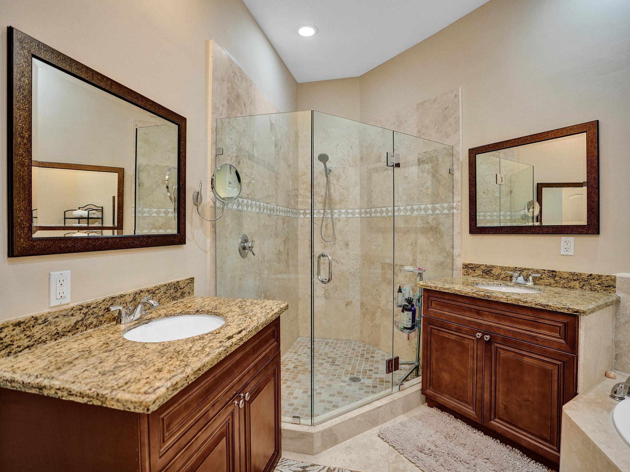 17288 Hampton Boulevard Boca Raton, FL 33496 - Photo 14 of 36 a bathroom with a granite countertop sink a mirror a vanity and shower