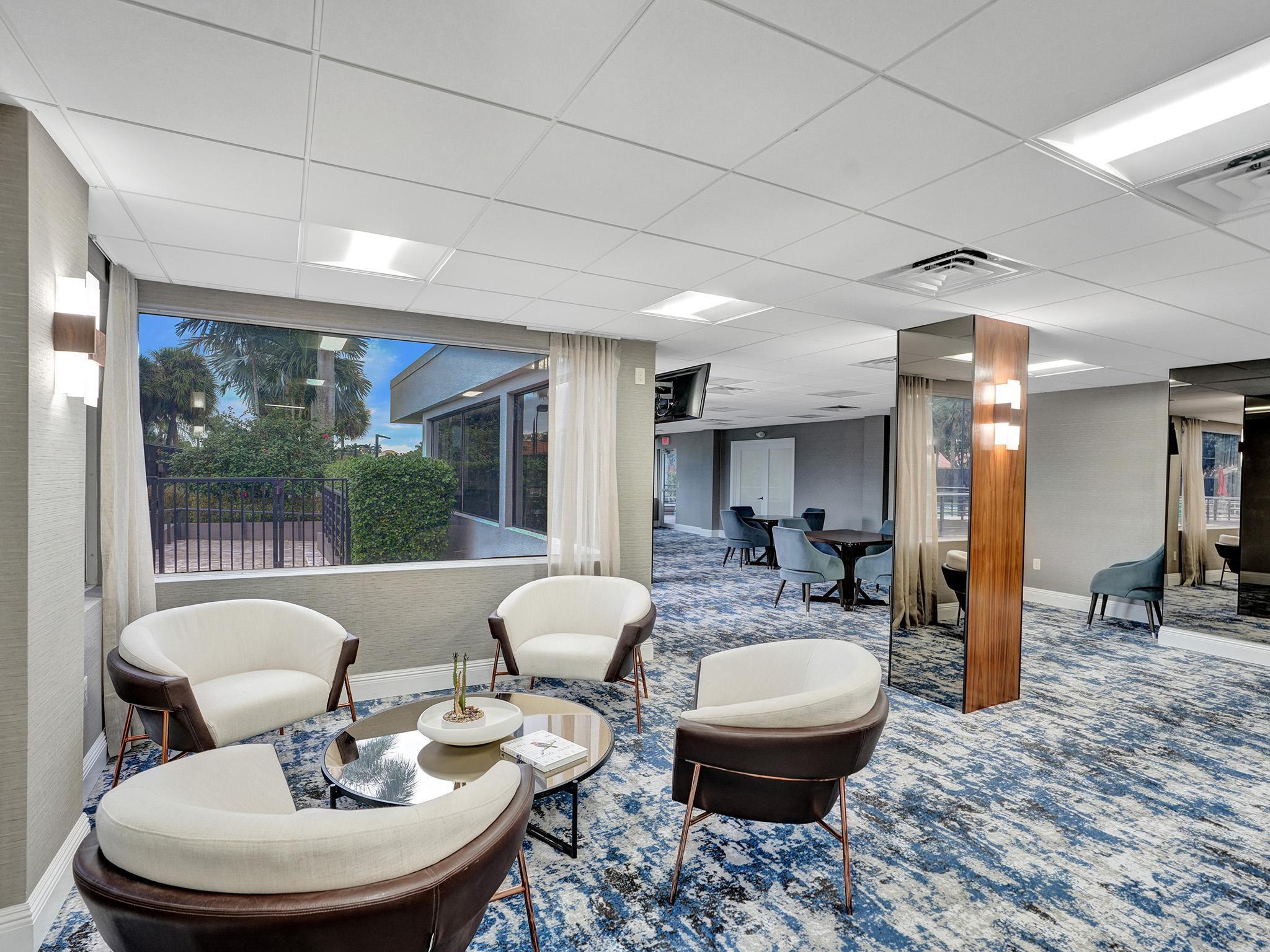 17288 Hampton Boulevard Boca Raton, FL 33496 - Photo 29 of 36 a living room with furniture and a large window