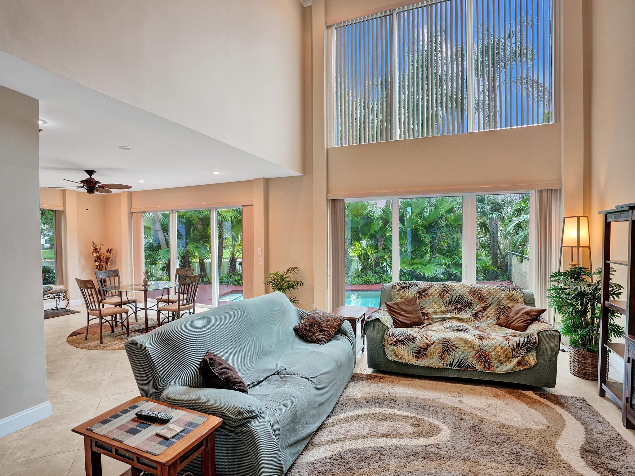 17288 Hampton Boulevard Boca Raton, FL 33496 - Photo 4 of 36 a living room with furniture and a large window
