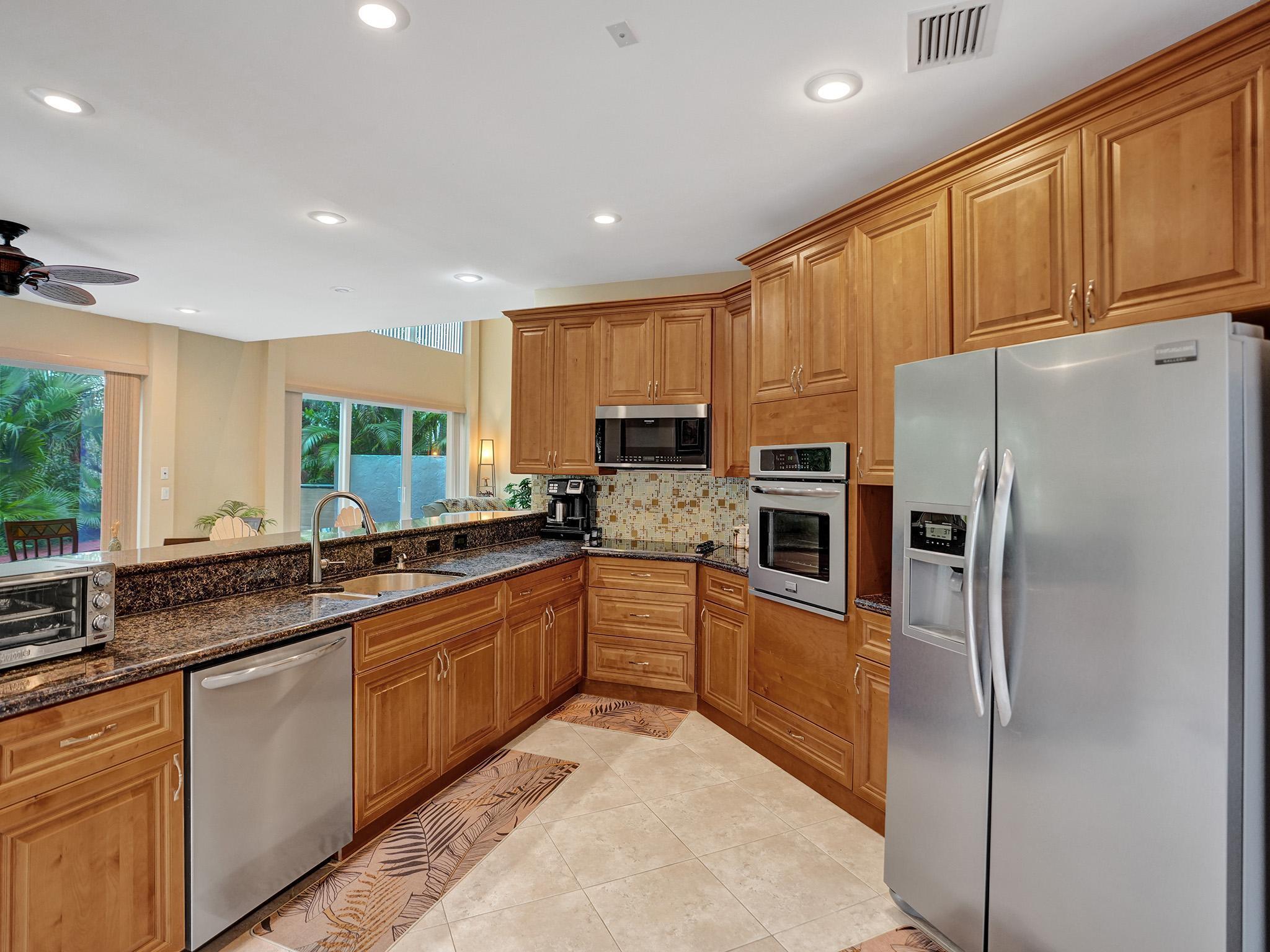 17288 Hampton Boulevard Boca Raton, FL 33496 - Photo 10 of 36 a large kitchen with stainless steel appliances granite countertop a refrigerator and a sink
