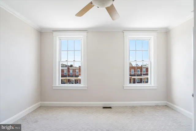 an empty room with windows and closet
