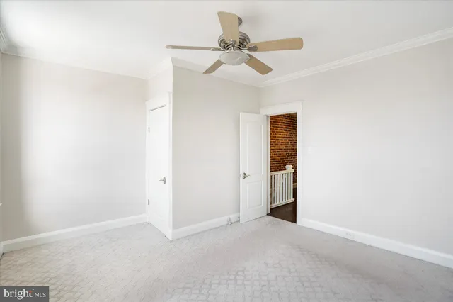 a view of a livingroom with a ceiling fan and window