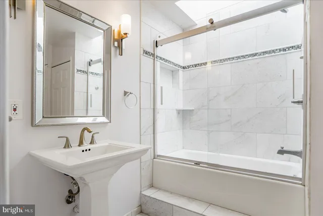 a bathroom with a shower and a sink