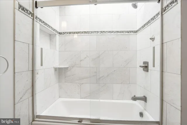a bathroom with a shower and a bath tub