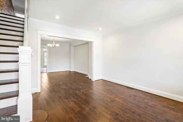 a view of empty room with wooden floor