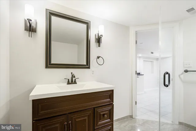 a view of multiple house with large windows and kitchen