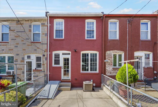 a front view of a house with outdoor seating