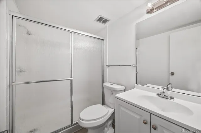 a bathroom with a sink toilet and vanity
