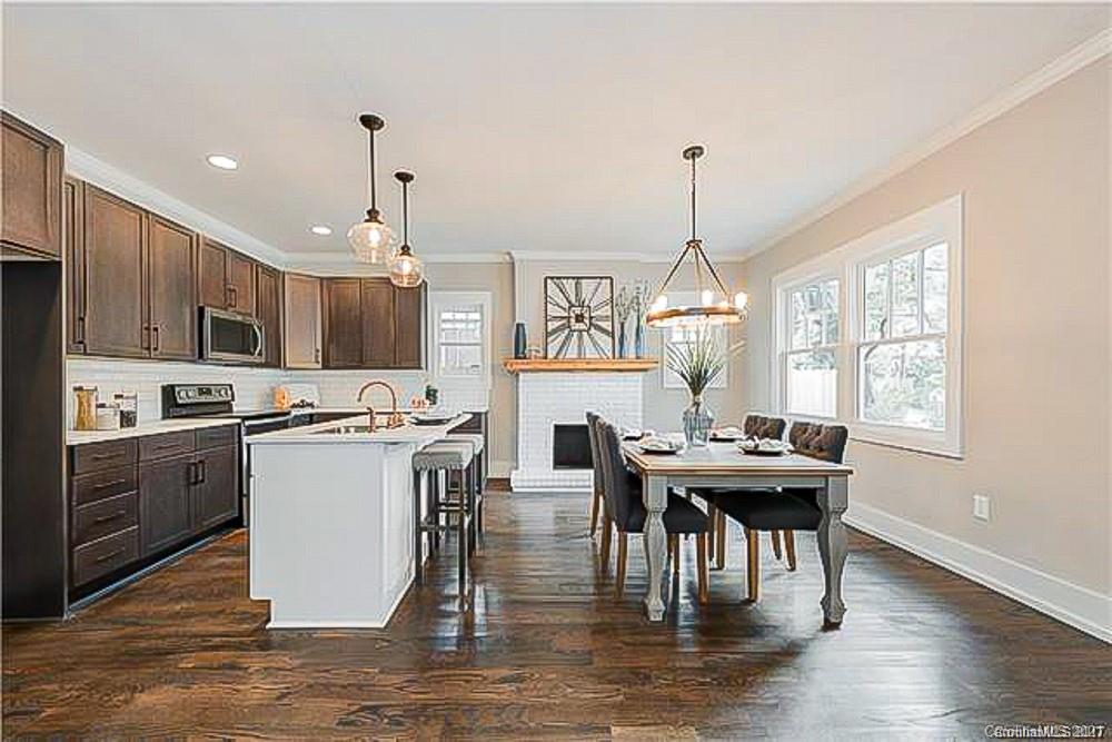 2116 Rozzelles Ferry Road Charlotte, NC 28208 - Photo 11 of 24 a living room with stainless steel appliances kitchen island granite countertop a dining table chairs and a wooden floor