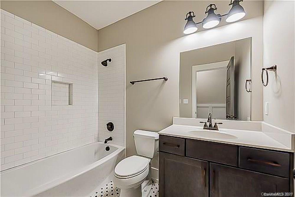 2116 Rozzelles Ferry Road Charlotte, NC 28208 - Photo 18 of 24 a bathroom with a sink a toilet and shower a mirror