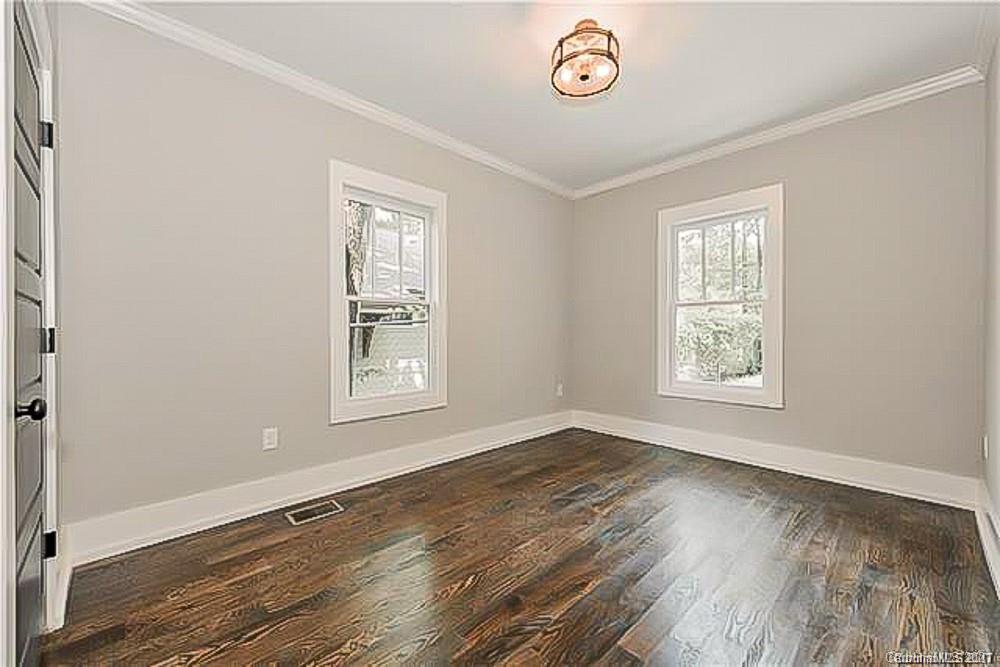 2116 Rozzelles Ferry Road Charlotte, NC 28208 - Photo 20 of 24 an empty room with wooden floor and windows