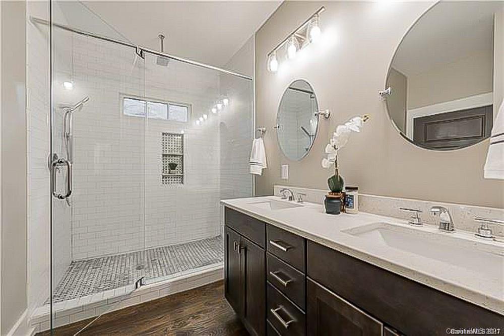 2116 Rozzelles Ferry Road Charlotte, NC 28208 - Photo 24 of 24 a bathroom with a double vanity sink a large mirror and shower