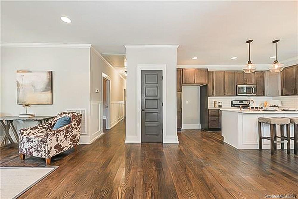 2116 Rozzelles Ferry Road Charlotte, NC 28208 - Photo 4 of 24 a living room with stainless steel appliances kitchen island granite countertop furniture and wooden floor