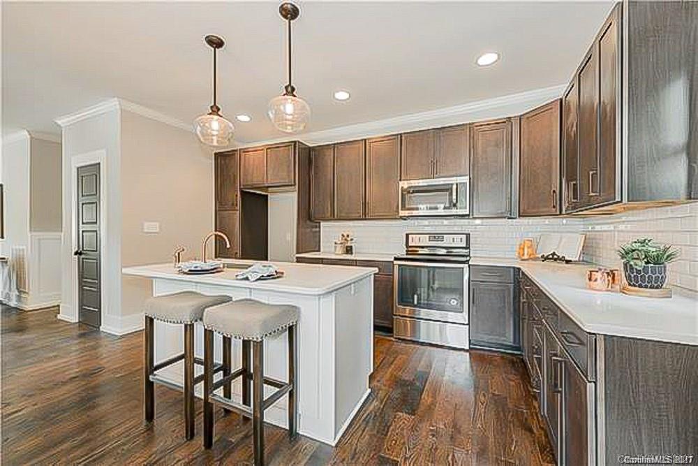 2116 Rozzelles Ferry Road Charlotte, NC 28208 - Photo 7 of 24 a kitchen with a stove a sink and a refrigerator