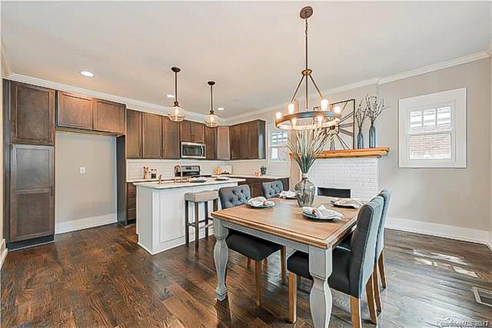 2116 Rozzelles Ferry Road Charlotte, NC 28208 - Photo 10 of 24 a kitchen that has a table chairs stainless steel appliances and wooden floor