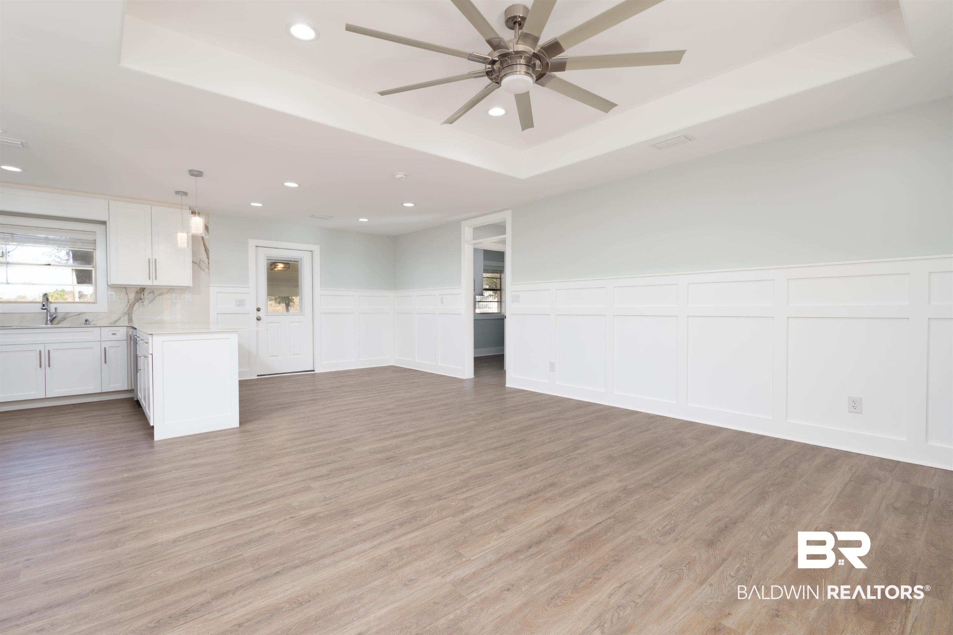 18267 Highway 98 Foley, AL 36535 - Photo 3 of 26 Unfurnished living room featuring a raised ceiling, light wood finished floors, recessed lighting, a decorative wall, and a ceiling fan