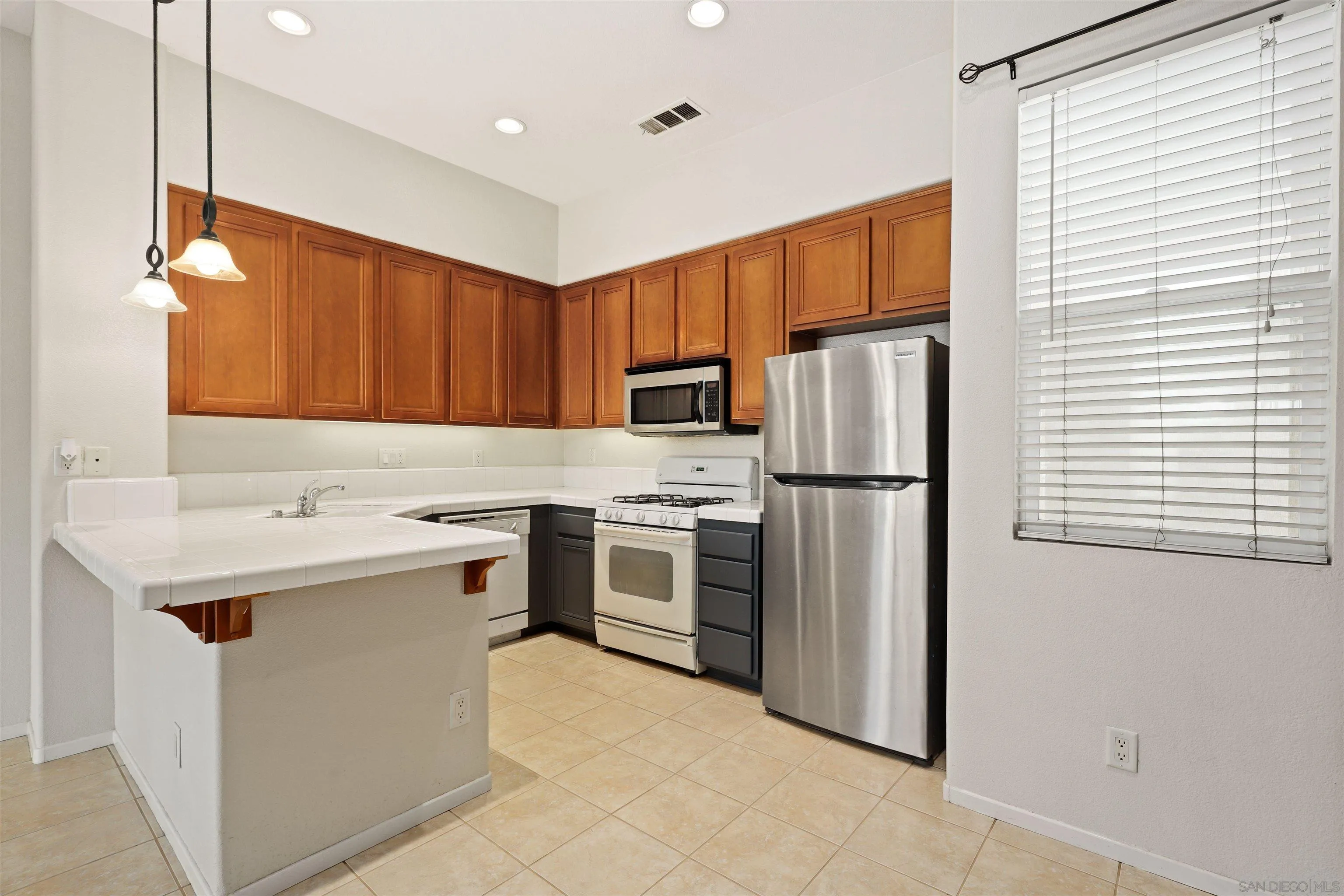 572 Almond Road San Marcos, CA 92078 - Photo 4 of 28 a kitchen with stainless steel appliances a refrigerator sink and microwave