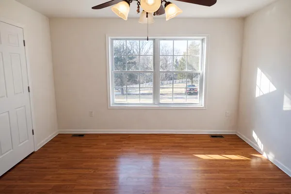 wooden floor in an empty room with a window