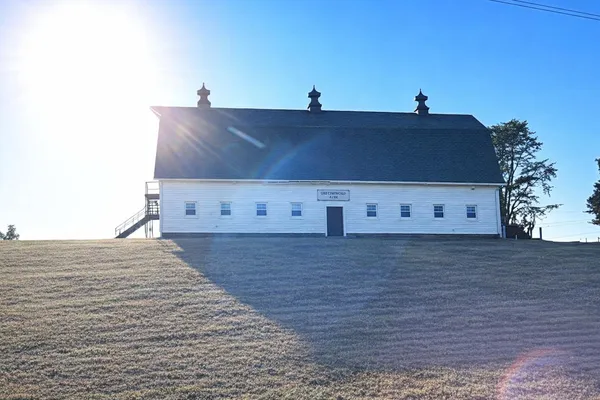 a view of dirt field with trees
