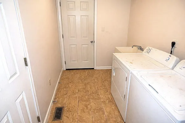 a utility room with a sink a washer and dryer