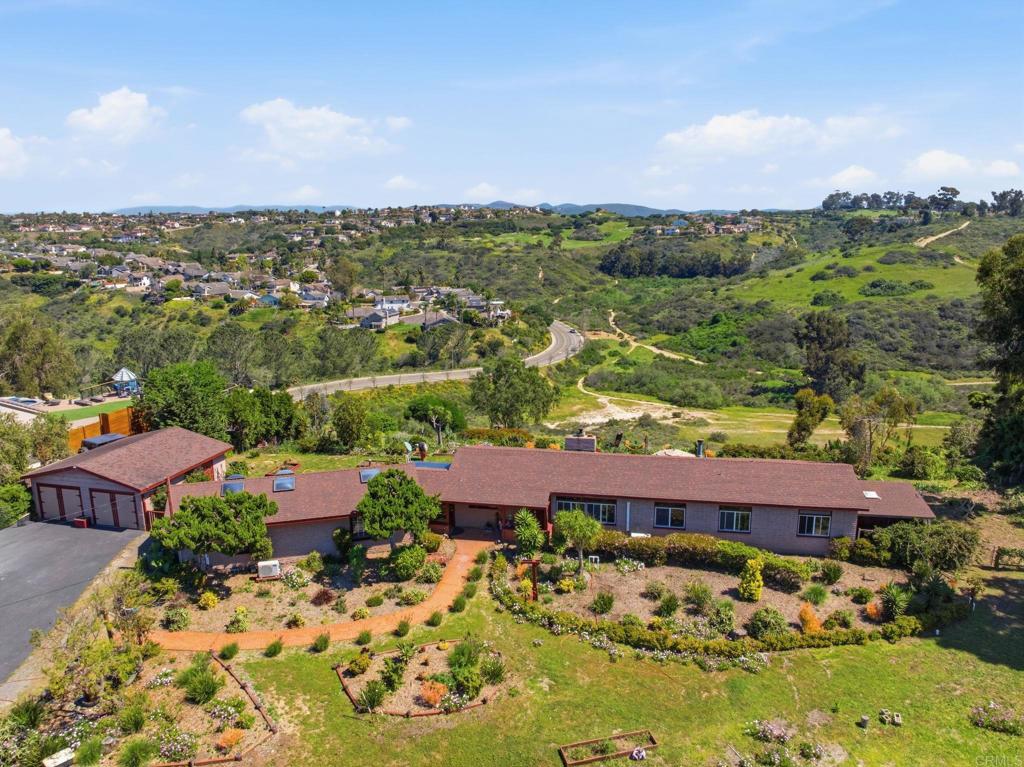 an aerial view of residential houses with outdoor space and street view