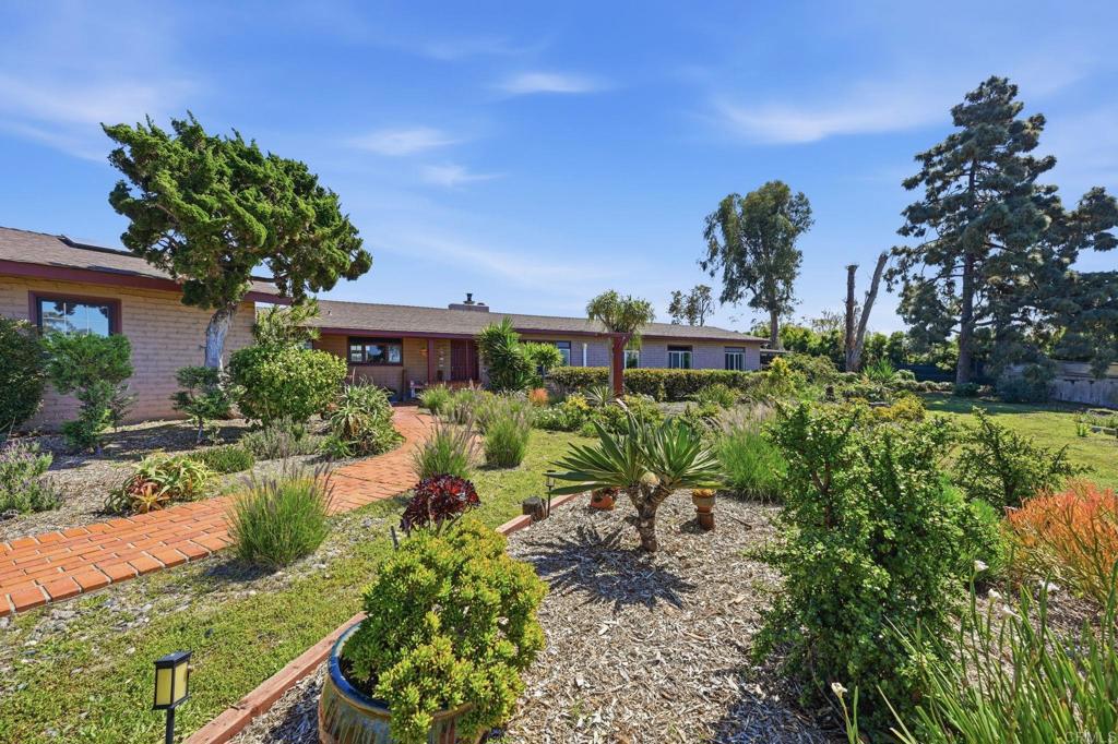 1355 Rainbow Ridge Lane Encinitas, CA 92024 - Photo 11 of 45 a view of a garden with a flower in a garden