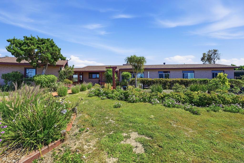 1355 Rainbow Ridge Lane Encinitas, CA 92024 - Photo 13 of 45 a front view of a house with a yard