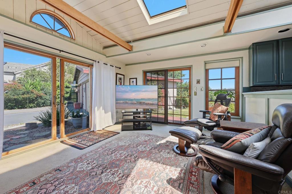 1355 Rainbow Ridge Lane Encinitas, CA 92024 - Photo 17 of 45 a living room with furniture large windows and wooden floor