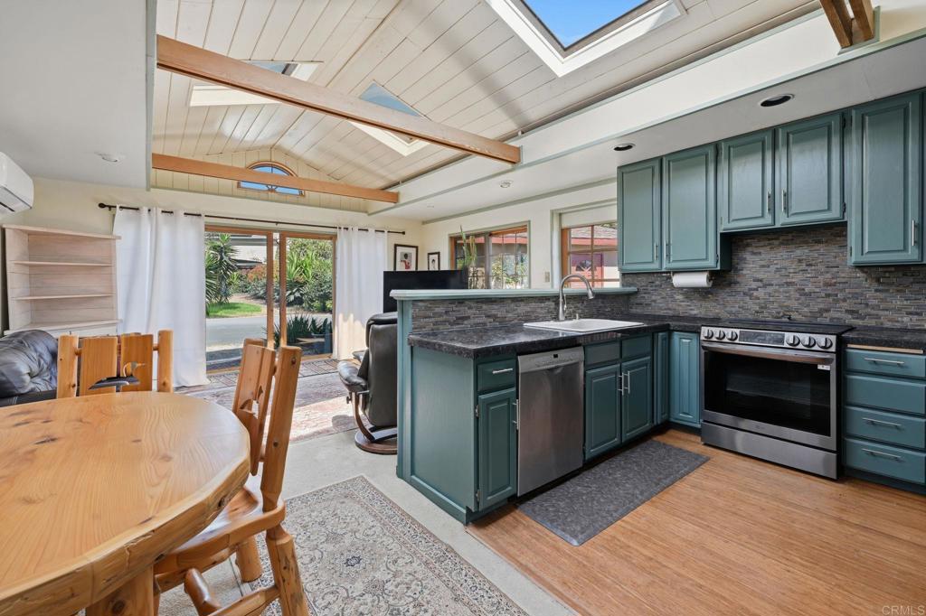 1355 Rainbow Ridge Lane Encinitas, CA 92024 - Photo 19 of 45 a kitchen with stainless steel appliances granite countertop a stove a sink and a refrigerator