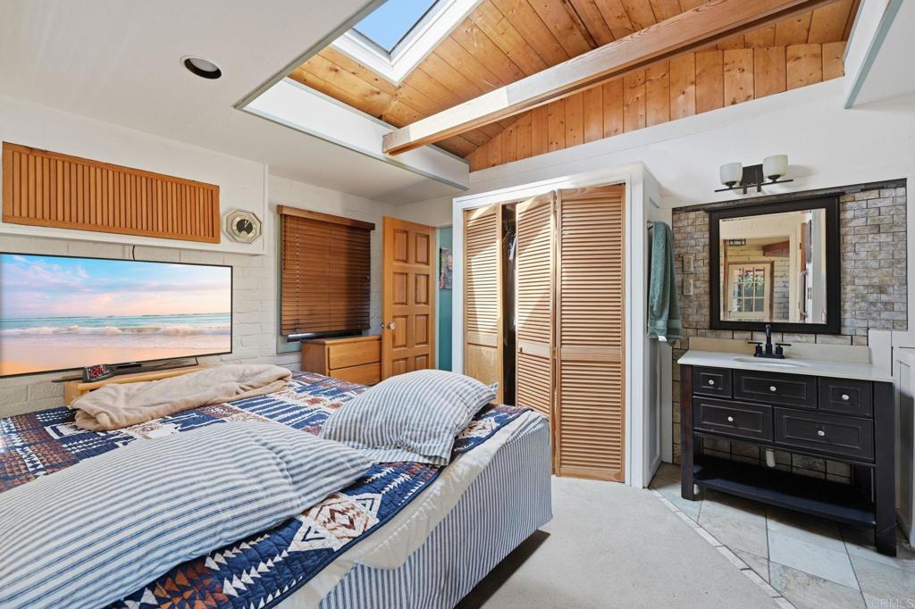 1355 Rainbow Ridge Lane Encinitas, CA 92024 - Photo 20 of 45 a bedroom with a bed and a dresser