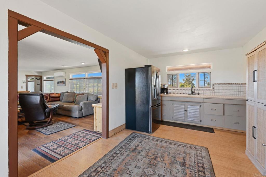 1355 Rainbow Ridge Lane Encinitas, CA 92024 - Photo 24 of 45 a large bedroom with a bed and glass door