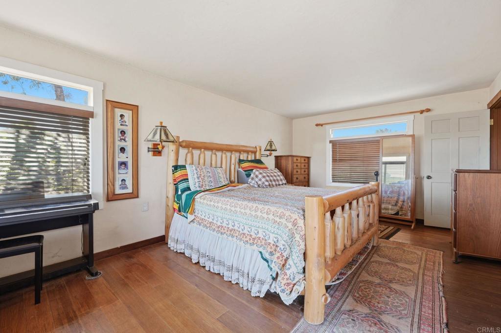 1355 Rainbow Ridge Lane Encinitas, CA 92024 - Photo 28 of 45 a bedroom with a bed and a large window