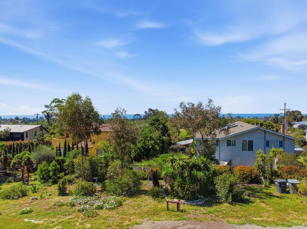 1355 Rainbow Ridge Lane Encinitas, CA 92024 - Photo 39 of 45 a front view of a house with a yard