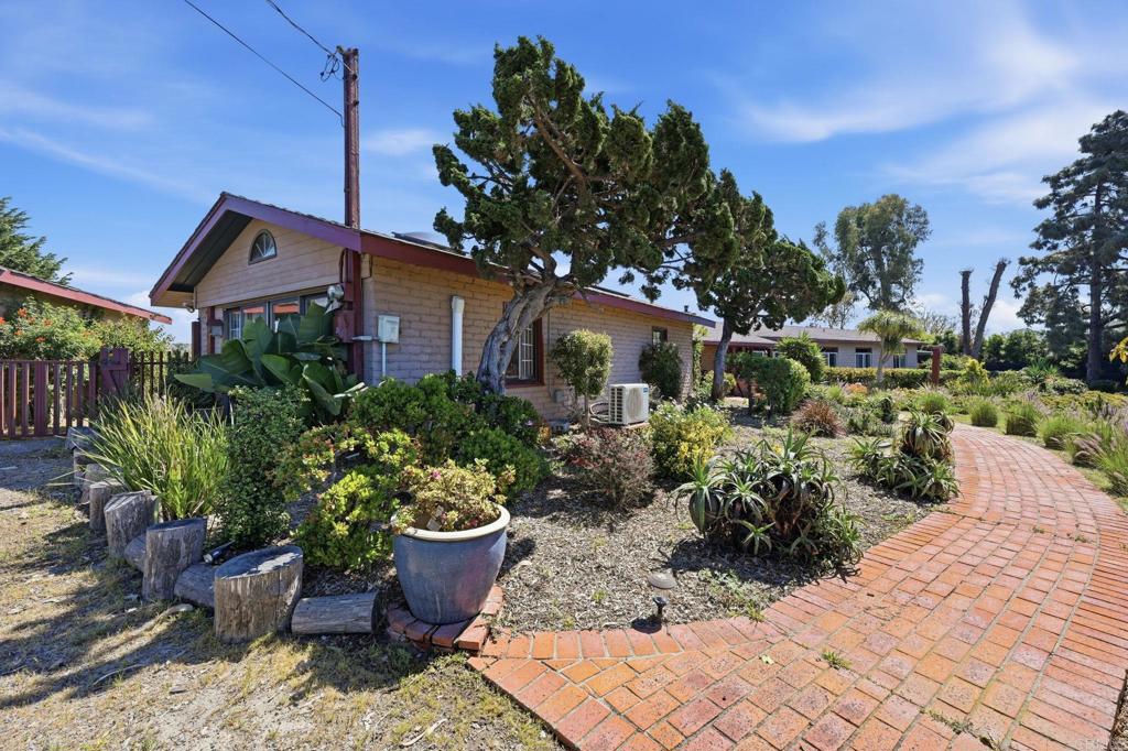 1355 Rainbow Ridge Lane Encinitas, CA 92024 - Photo 10 of 45 a front view of a house with a yard
