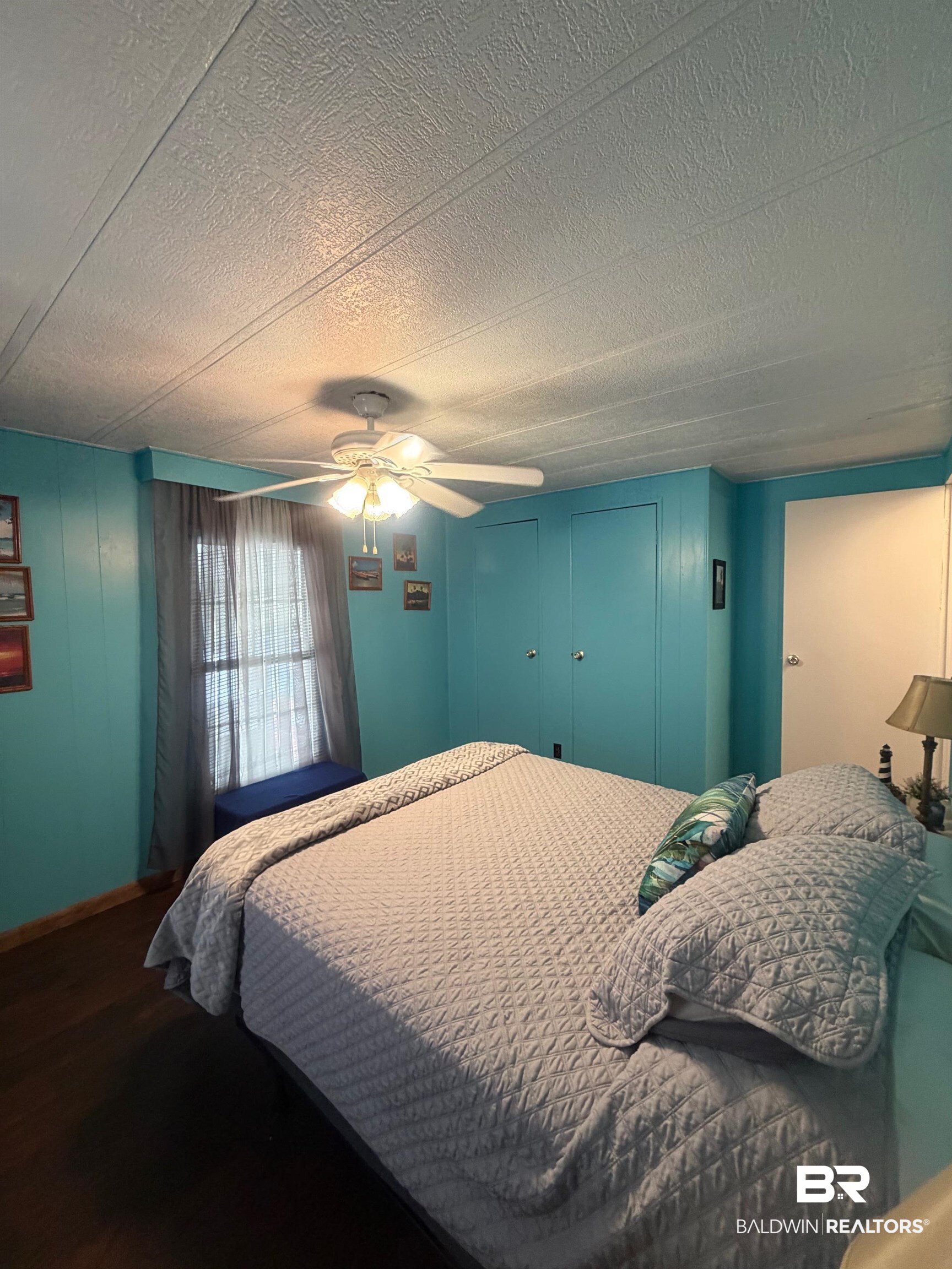 1430 Ridgewood Drive Lillian, AL 36549 - Photo 12 of 34 Bedroom with a ceiling fan and wood finished floors